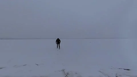 Slow big steps in the snow, moving away into the distance during a snowfall Stock Footage 150035910