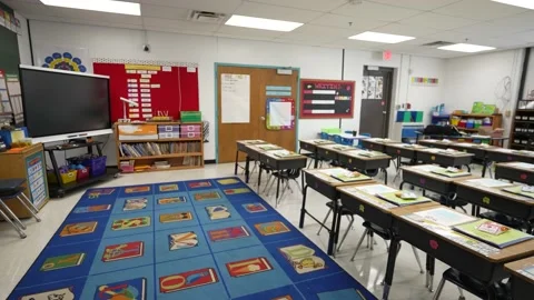 Slow boom up from floor to US flag to showing an empty school classroom during 스톡 동영상 159239168