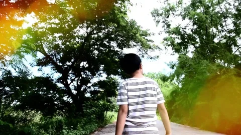 Slow boy walking in the park Stock Footage 80295683