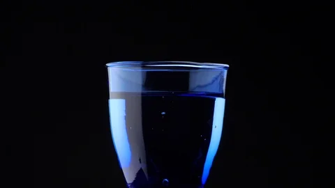 Slow Bubbles in Blue Glass Stock Footage 98910659