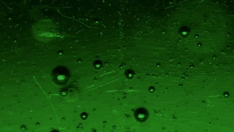 Slow Bubbles in a Dark Green Liquid - Macro video Stock Footage 125530971