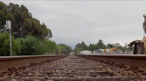 Slow camera dolly of train tracks down the horizon with trees Stock-Footage 60142825