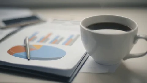 Slow camera motion over white table whith cup of coffee and documents Stock Footage 72817105