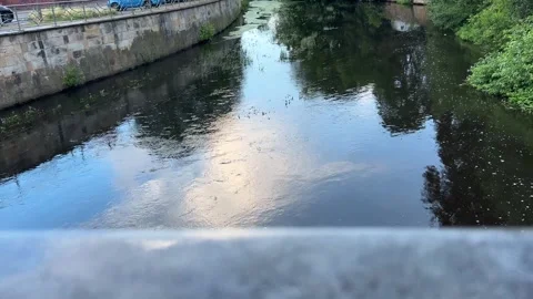 Slow Camera Move Above Urban Canal with Cloud Reflections Stock Footage 340443137