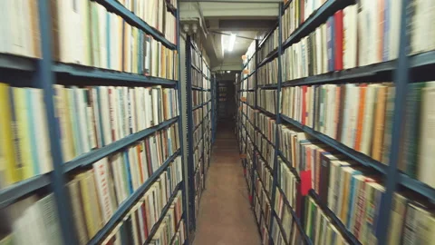Slow camera movement between two archive shelves filled with folders Stock Footage 99329878
