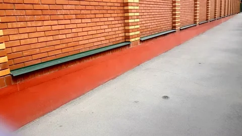 Slow camera movement up a brick wall, modern masonry, new orange bricks, outdoor Stock Footage 137959854
