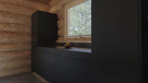 Slow camera movement revealing the interior of a modern kitchen inside a rustic Stock Footage 335757323