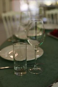 Slow camera pan over elegant glassware on a green tablecloth Stock Photos