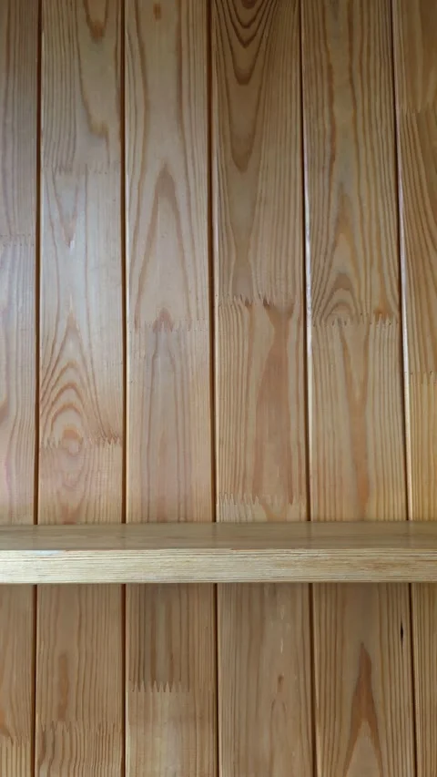 Slow camera pan right across rustic wooden wall with shelf Stock Footage 345449219