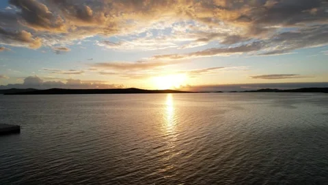 Slow camera push forward over the sea towards a golden sunrise, drone view Vídeos de archivo 335422042