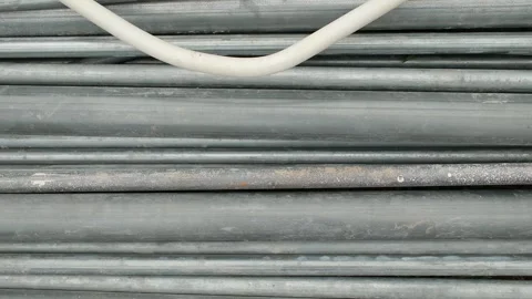 Slow Camera Slide Across Industrial Pipes and Construction Materials Vídeos de archivo 337623719