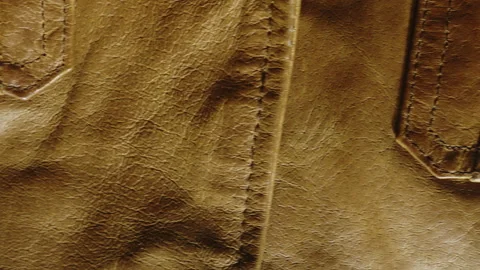 Slow Camera Slide Over Rich Brown Leather Jacket Surface and Texture Stock Footage 340856962