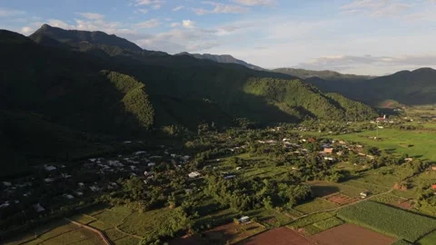 Slow cinematic drone flight over mountain valley at golden hour in Vietnam Stock Footage 337948361