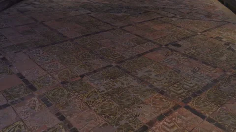 Slow cinematic pan across medieval encaustic floor tiles inside Cleeve Abbey Stock Footage 340269315