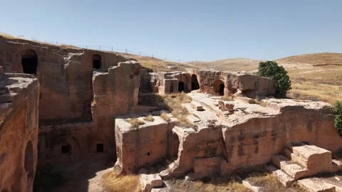 Slow Cinematic Push-In Toward Ancient Cave Structures in Dara Ancient City Stock Footage 334793214