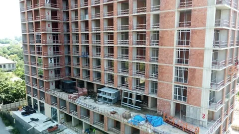 Slow Climb Up: Side View of Brick House Under Construction Stock Footage 292521295