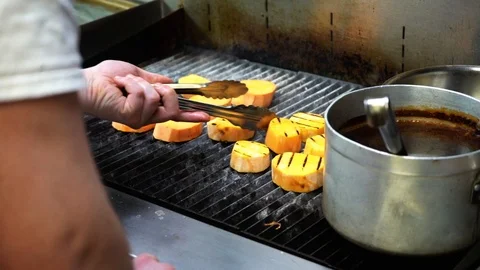Slow close up of chef flipping and pressing food on the stove Stock Footage 107165053