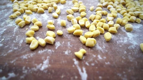 Slow close-up panning of floured struffoli on wooden board Stock Footage 278841107