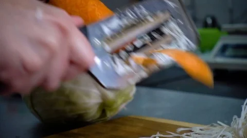 SLOW-CLOSEUP: the chef cleans the carrot in the kitchen Stock-Footage 81362775