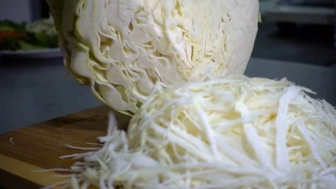 SLOW-CLOSEUP: Hand with knife cuts cabbage Stock Footage 81362598