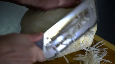 SLOW-CLOSEUP: Hand with knife cuts cabbage Stock Footage 81362670