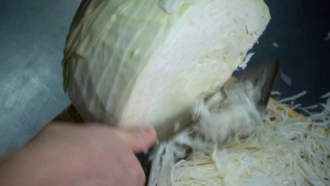 SLOW-CLOSEUP: Hand with knife cuts cabbage Stock Footage 81362710