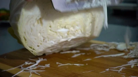 SLOW-CLOSEUP: Hand with knife cuts cabbage Stock Footage 81362716