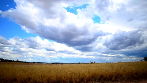 Slow cloud time-lapse on a straw farm Stock Footage 145926140