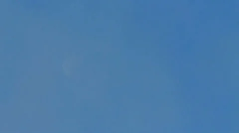 Slow clouds pass half moon during bright daytime Video stock 36584759