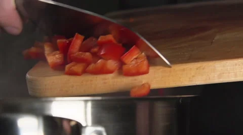 SLOW: Cook throws a sliced bell pepper (close up) Stock Footage 63626307