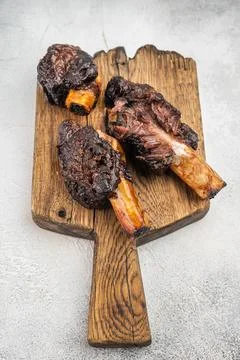 Slow cooked beef short ribs with bone on wooden board and BBQ sauce. Tender.. Stock Photos