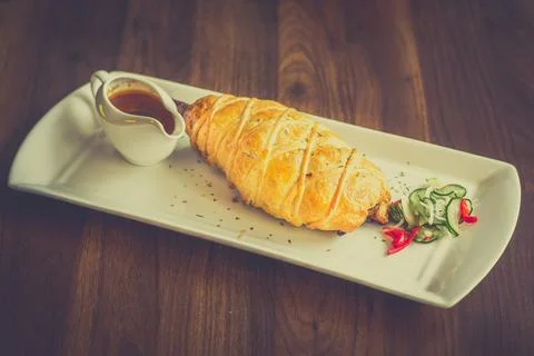 Slow-cooked, fall off the bone lamb shank rendang wellinton encrusted in bu.. Foto stock