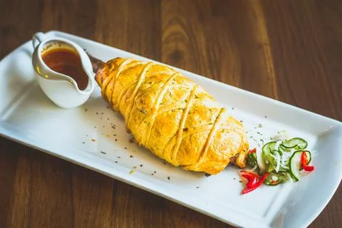 Slow-cooked, fall off the bone lamb shank rendang wellinton encrusted in bu.. Stock Photos