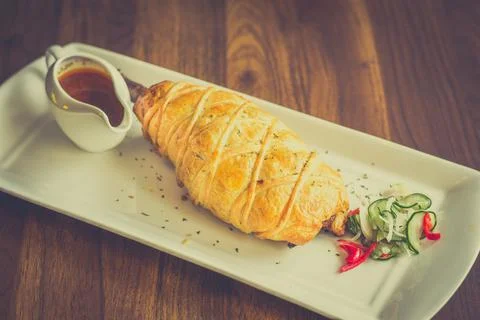 Slow-cooked, fall off the bone lamb shank rendang wellinton encrusted in bu.. Stock Photos