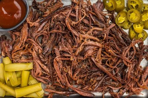 Slow cooked pulled beef with jalapeno slices and pickles, barbecue meat tra.. Stock Photos