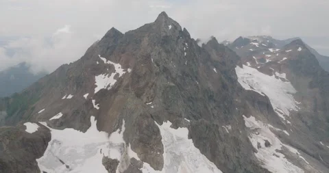 Slow Counter Clockwise Aerial Orbit of Glacier Covered Mountain Stock Footage 290059233