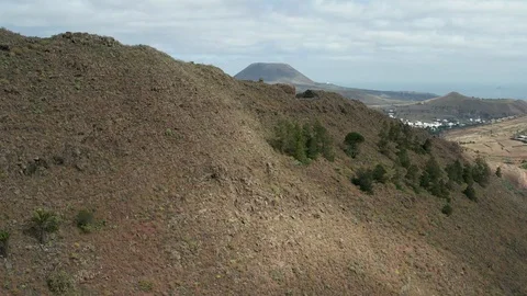 Slow crane style shot on far city behind the hill Stock Footage 104420672