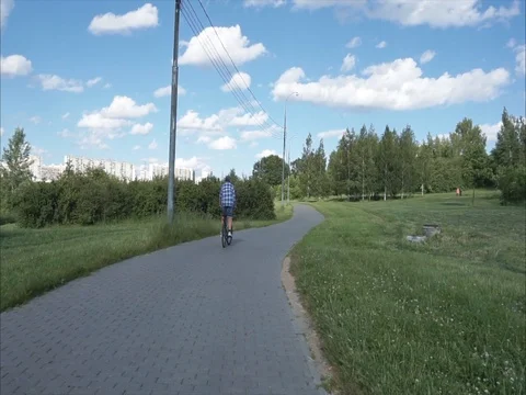 Slow cycling rear view Stock Footage 77663301