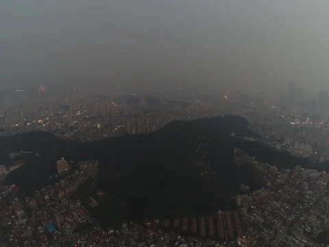 Slow decline showing a small mountain and apartments at dusk in Seoul Stock Footage 77961762