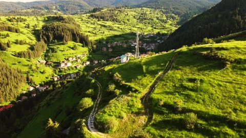 Slow Descend FPV Dive Through Hills Reveal Hidden Village Neighborhood Stock Footage 274141724