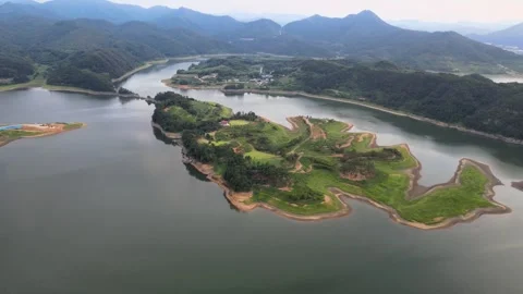 Slow Descending Drone View of a Green Island and Lake in Summer, South Korea Stock Footage 343194261