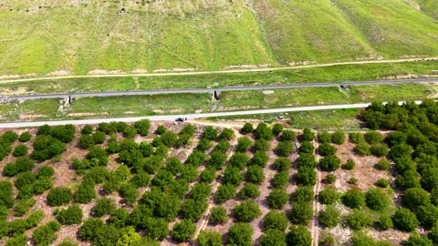 Slow Descending Forward Shot Over Farmland Toward Road and Railway, 4K 60fps Stock Footage 336869864
