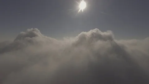 Slow descent into beautiful Clouds with the sun in front, 4K Stock Footage 72936010