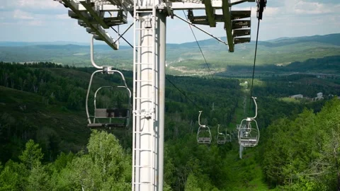 A slow descent by cable car with views of the mountains and the picturesque Stock Footage 274064228