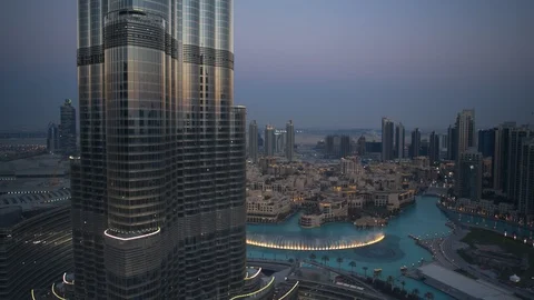 Slow descent down Burj Khalifa from 200m to 150m, with dubai fountain visible Stock Footage 98958642