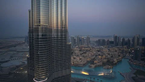 Slow descent down Burj Khalifa from 250m to 200m, with dubai fountain visible Stock Footage 99033574