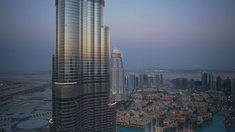 Slow descent down Burj Khalifa from 350m to 250m, revealing dubai fountain, Stock Footage 99034259