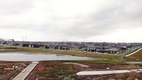 Slow Descent Over Lake Development and Large Housing Estate Aerial 4K Stock Footage 139127575