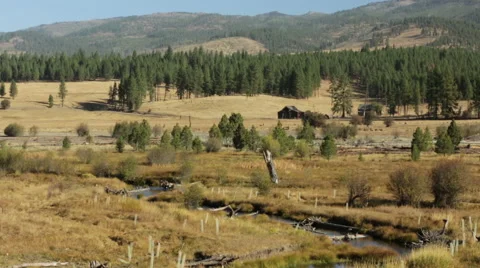 SLOW DESERT RIVER AND CABIN IN EARLY EVENING Stock Footage 53129074