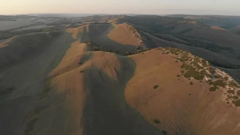 Slow direct aerial flight over bald steppe mountains. Video stock 155998539